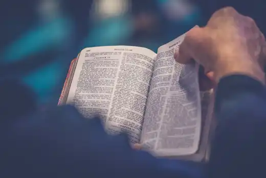 Open Bible beside a quiet window